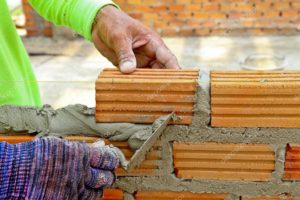 depositphotos_31675959-stock-photo-worker-create-a-brick-wall