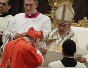 New Cardinal Giovanni Angelo Becciu receives the red three-cornered biretta hat from Pope Francis during a consistory in St. Peter's Basilica at the Vatican, Thursday, June 28, 2018. Pope Francis made 14 new Cardinals during the consistory. (ANSA/AP Photo/Alessandra Tarantino) [CopyrightNotice: Copyright 2018 The Associated Press. All rights reserved.]